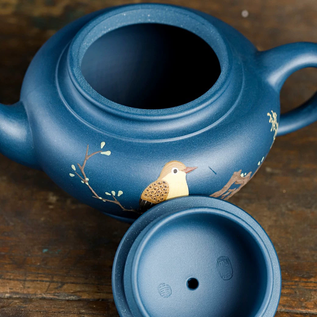 Small azure clay pot with smiling cherry blossoms