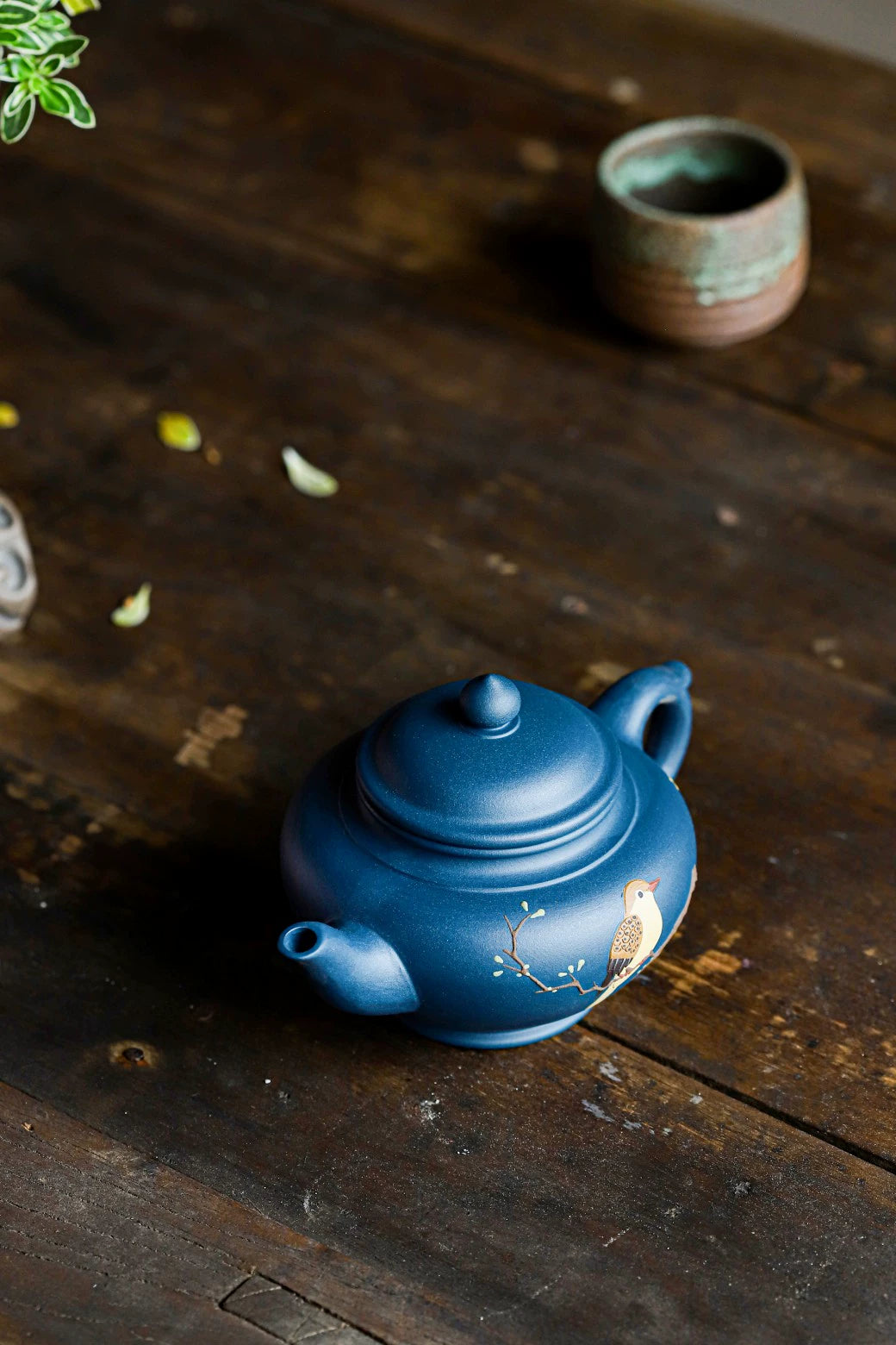 Small azure clay pot with smiling cherry blossoms