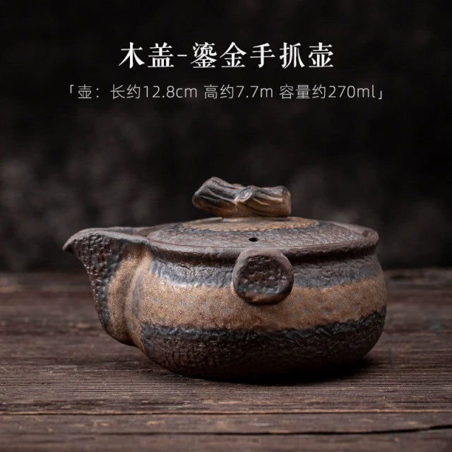 Coarse pottery teapot with gilded handle