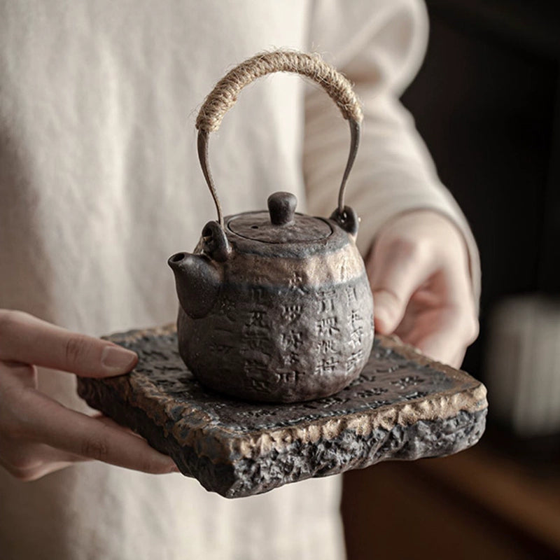 Coarse pottery teapot with gilded handle