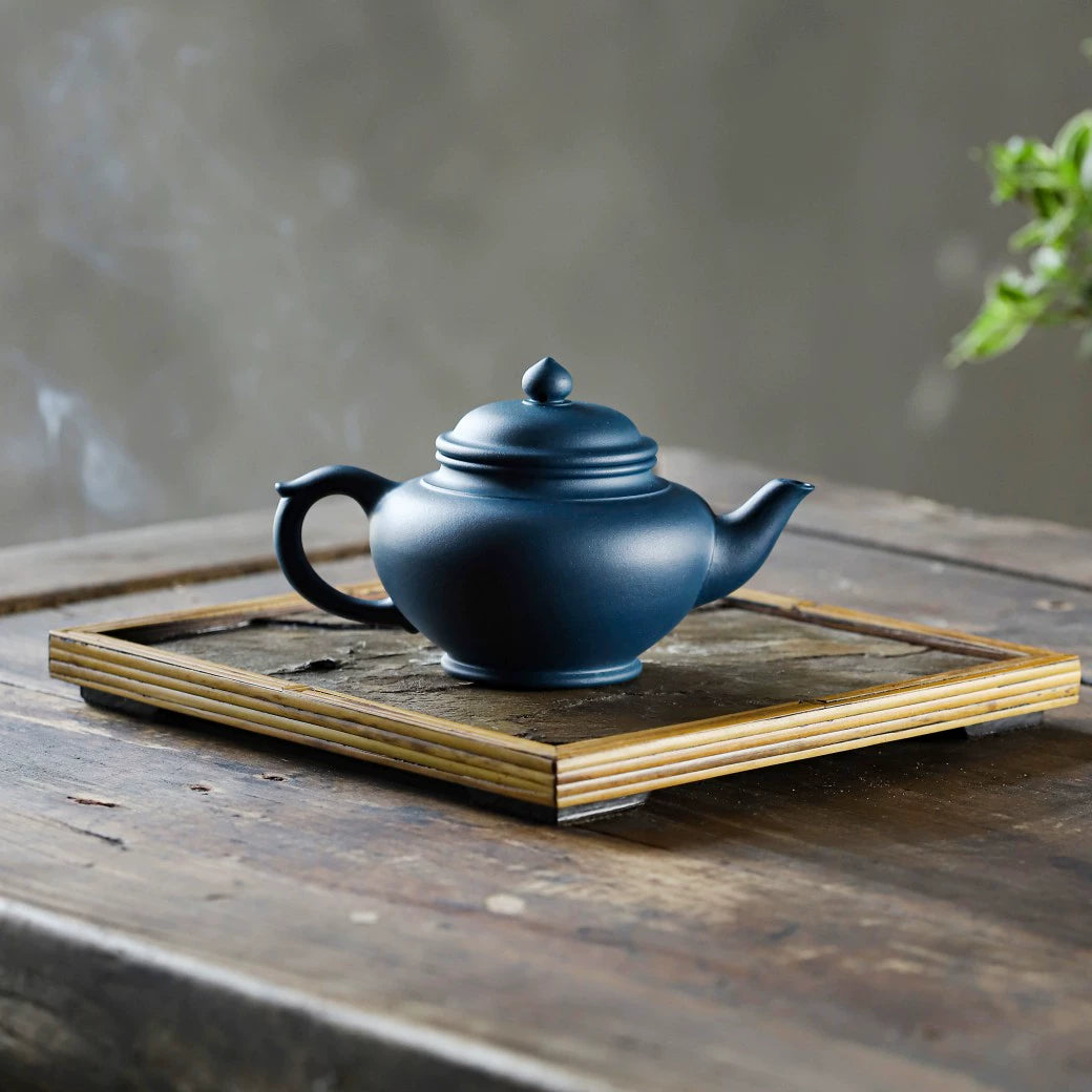 Small azure clay pot with smiling cherry blossoms