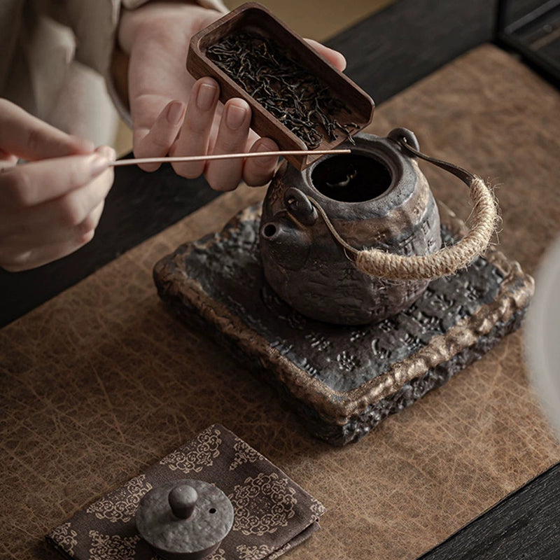 Coarse pottery teapot with gilded handle