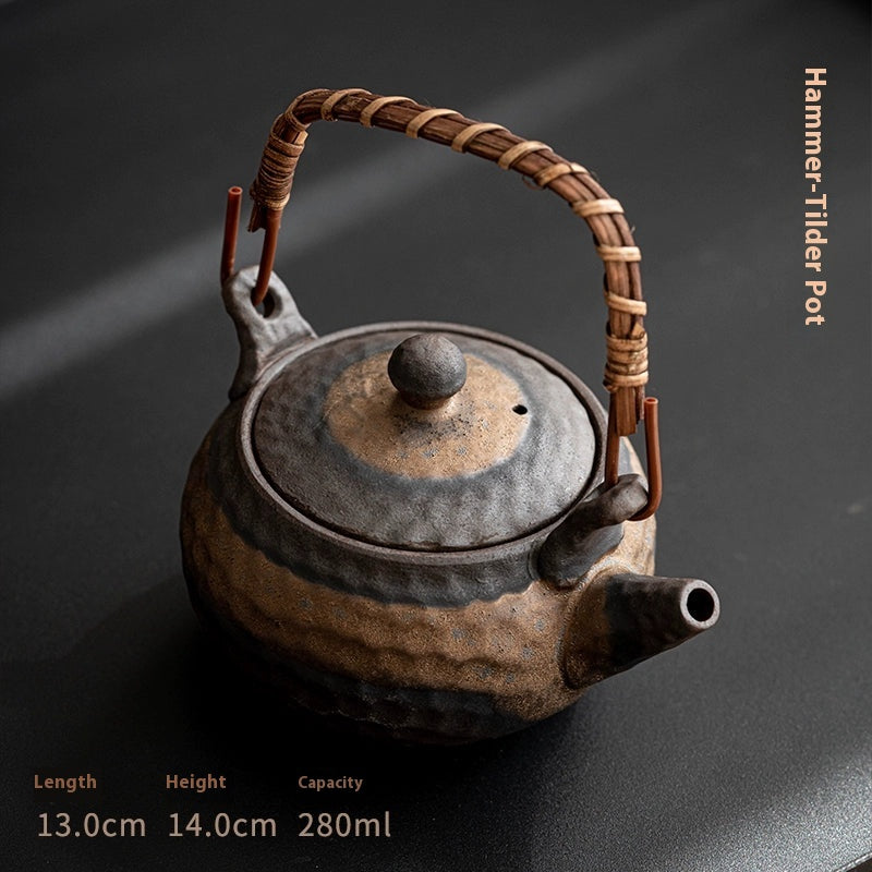 Coarse pottery teapot with gilded handle